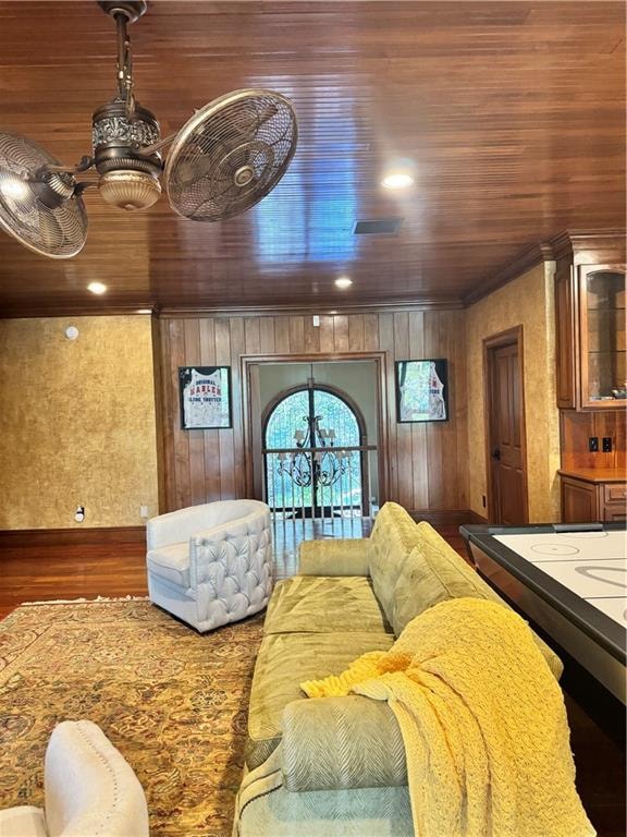 interior space featuring dark hardwood / wood-style flooring, wood ceiling, and wooden walls