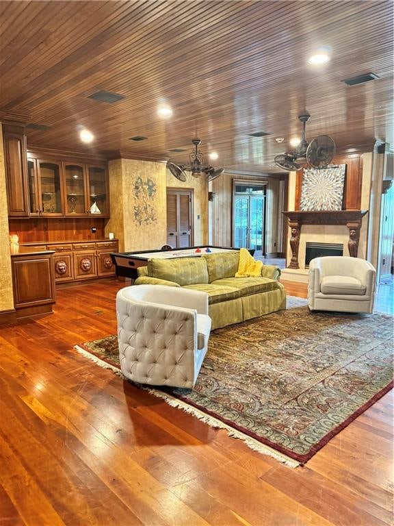 living room featuring a chandelier, wood-type flooring, wooden ceiling, and pool table