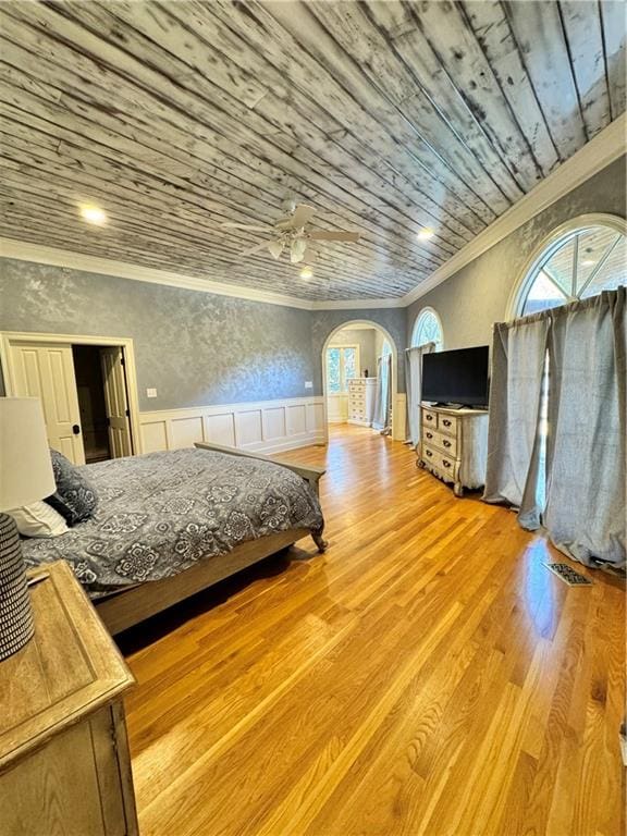 bedroom with ornamental molding, light wood-type flooring, ceiling fan, and wooden ceiling