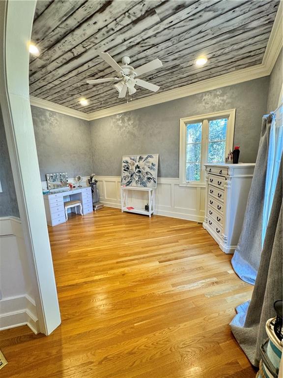 interior space with ceiling fan, light hardwood / wood-style flooring, and wooden ceiling