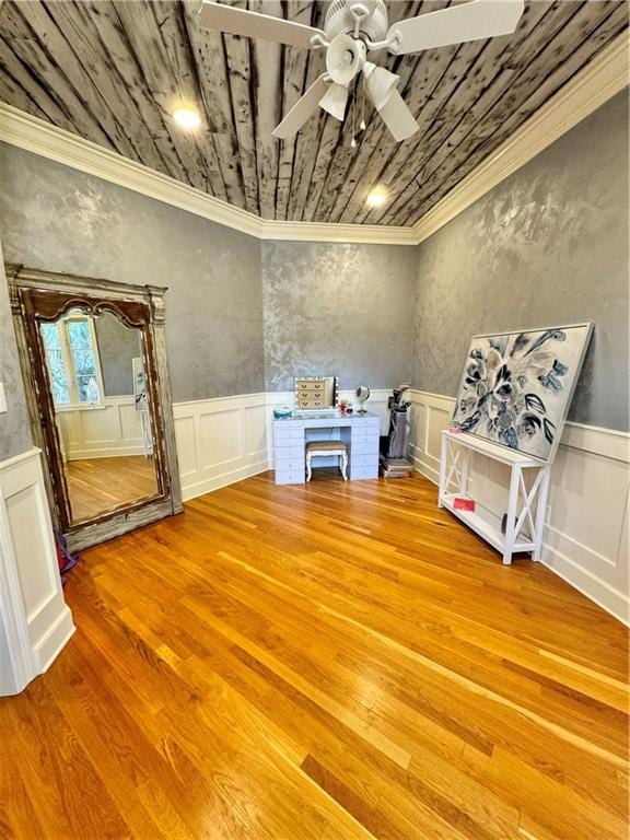 misc room with hardwood / wood-style floors, ceiling fan, and crown molding