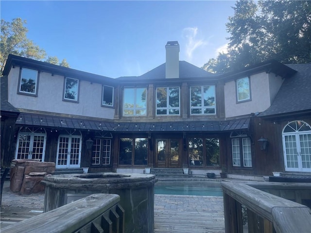 rear view of property featuring french doors