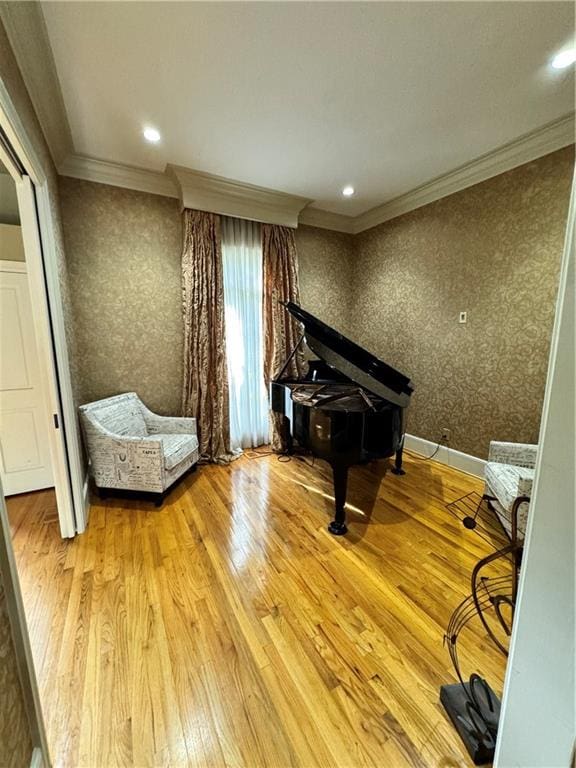 sitting room with crown molding and hardwood / wood-style floors