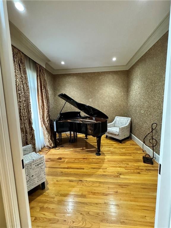 miscellaneous room featuring ornamental molding and light hardwood / wood-style flooring