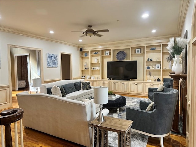 living room with light hardwood / wood-style flooring, ceiling fan, and ornamental molding