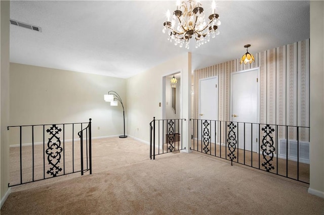 4205 Chesterfield Dr N, Mobile, AL 36618 - carpeted spare room featuring baseboards, a chandelier, and wallpapered walls