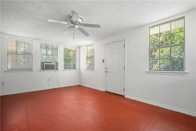 4205 Chesterfield Dr N, Mobile, AL 36618 - empty room with cooling unit, a textured ceiling, healthy amount of natural light, a ceiling fan, and baseboards
