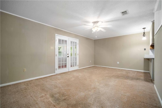 4205 Chesterfield Dr N, Mobile, AL 36618 - carpeted empty room with ceiling fan, french doors, ornamental molding, baseboards, and a textured ceiling