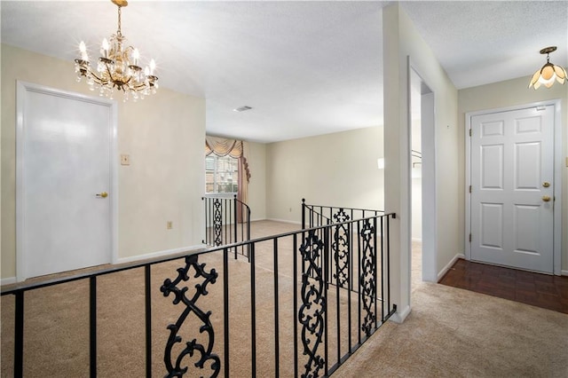 4205 Chesterfield Dr N, Mobile, AL 36618 - corridor with carpet flooring, an upstairs landing, a chandelier, and baseboards