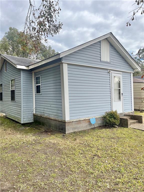 view of side of property with a lawn