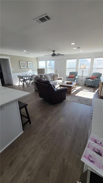 living room featuring dark hardwood / wood-style floors and ceiling fan