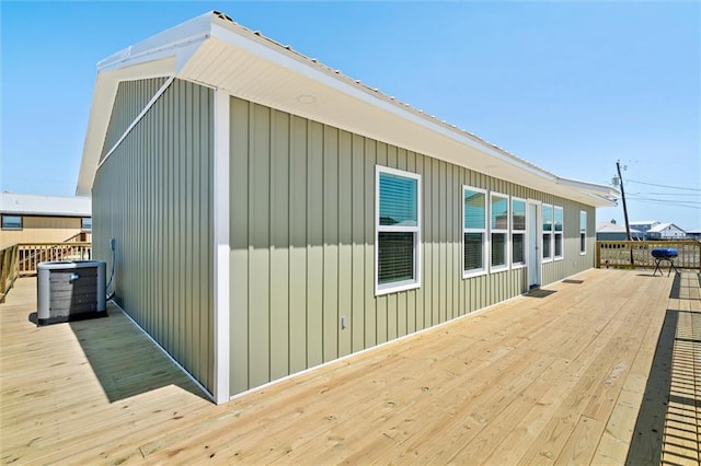 view of side of property featuring central AC and a wooden deck