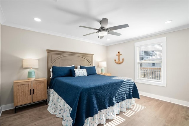 bedroom featuring ceiling fan, crown molding, and hardwood / wood-style flooring