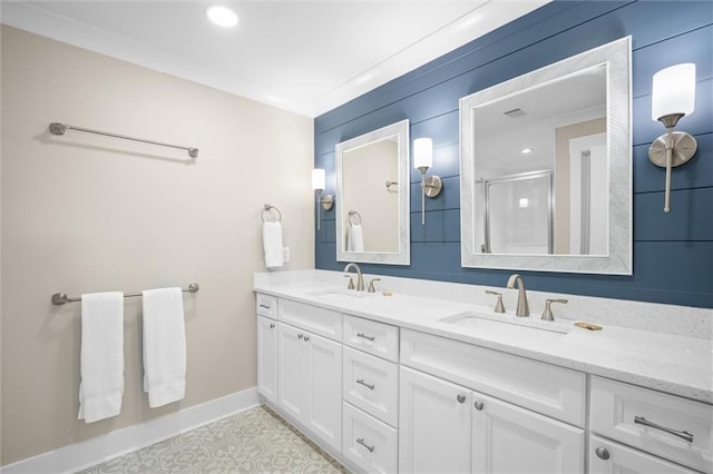 bathroom featuring vanity, an enclosed shower, and crown molding