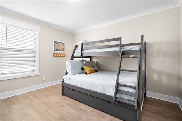 bedroom featuring crown molding and light hardwood / wood-style floors