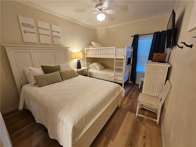 bedroom featuring dark hardwood / wood-style flooring, crown molding, and ceiling fan