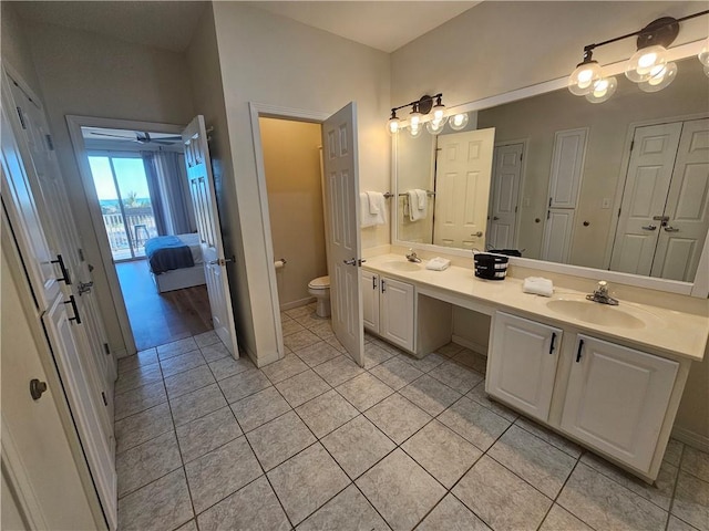 bathroom with vanity, tile patterned flooring, and toilet