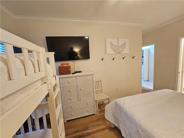 bedroom with crown molding and hardwood / wood-style floors