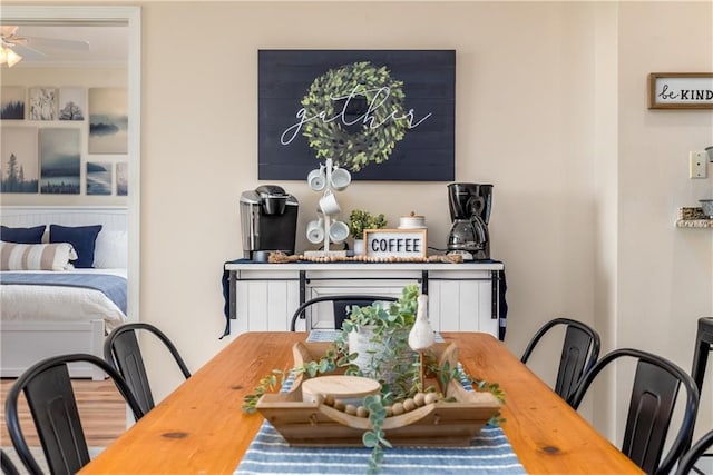 dining room with crown molding, wood-type flooring, and ceiling fan