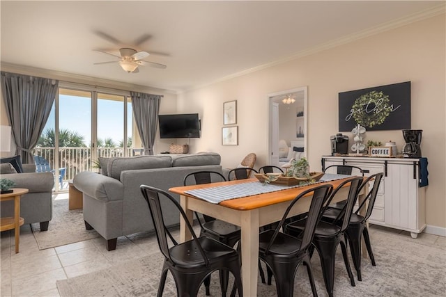 tiled dining room featuring ceiling fan and ornamental molding