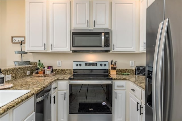 kitchen with white cabinetry, appliances with stainless steel finishes, and light stone countertops