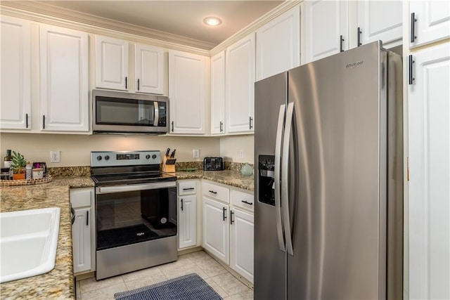 kitchen with white cabinetry, sink, stainless steel appliances, and light tile patterned flooring