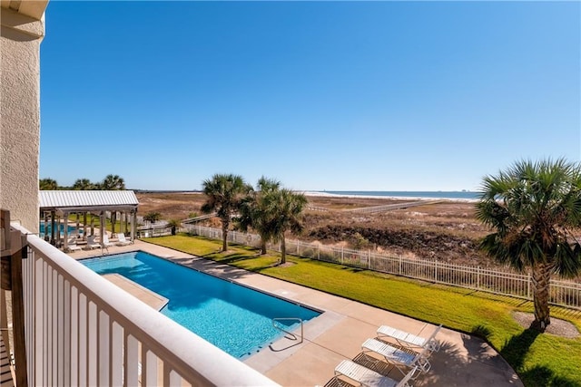 view of pool featuring a patio and a yard