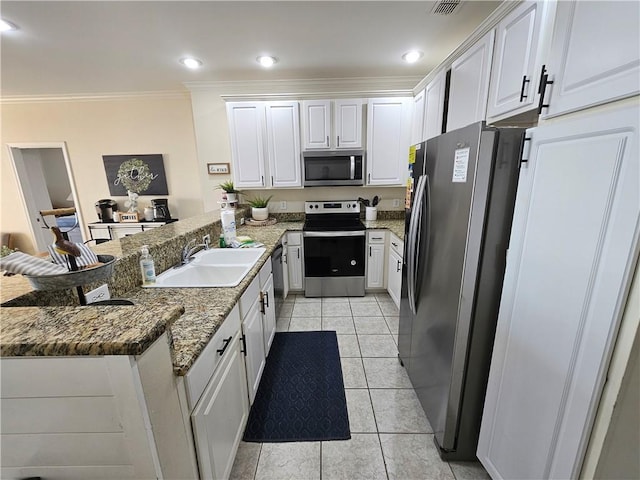 kitchen with stainless steel appliances, sink, and white cabinets