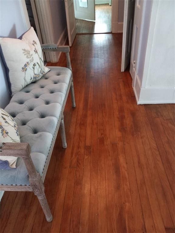 hallway with hardwood / wood-style flooring