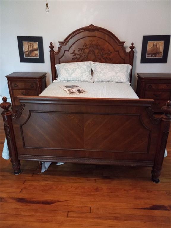 bedroom with dark wood-type flooring