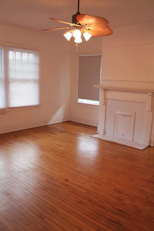 unfurnished living room featuring ceiling fan and light wood-type flooring