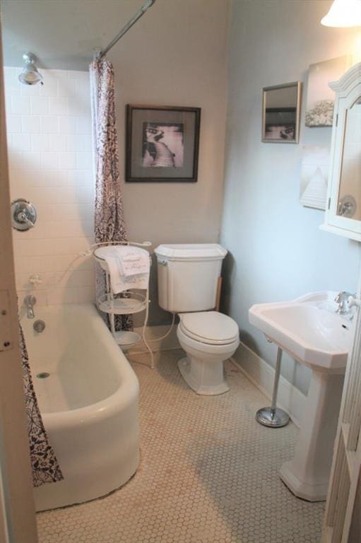 bathroom featuring shower / bath combination with curtain, tile floors, and toilet