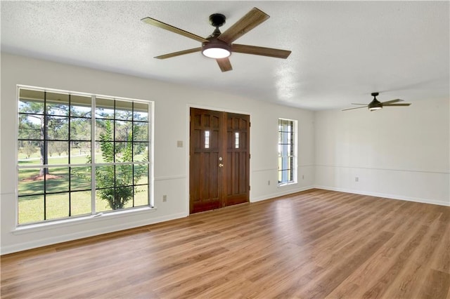 foyer featuring plenty of natural light, light hardwood / wood-style floors, and ceiling fan