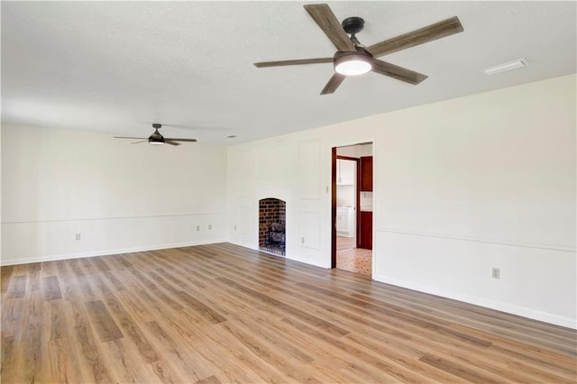 unfurnished living room with ceiling fan and light hardwood / wood-style flooring