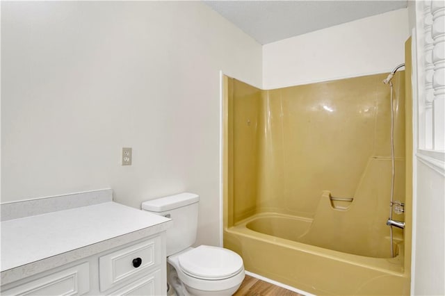 full bathroom featuring shower / bath combination, hardwood / wood-style floors, vanity, and toilet