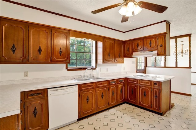 kitchen with white appliances, sink, kitchen peninsula, ornamental molding, and a textured ceiling