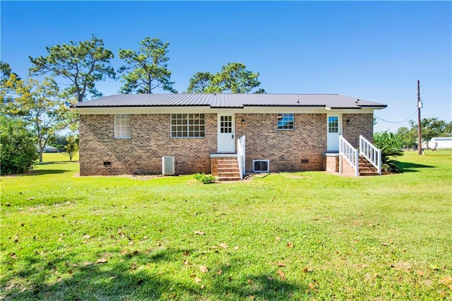 back of house with a yard and central AC unit