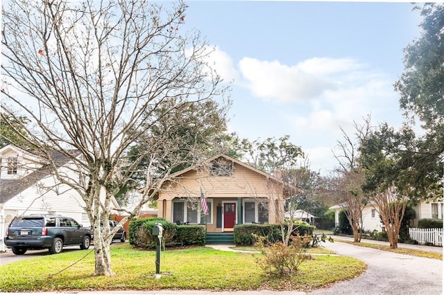 bungalow with a front lawn and a porch