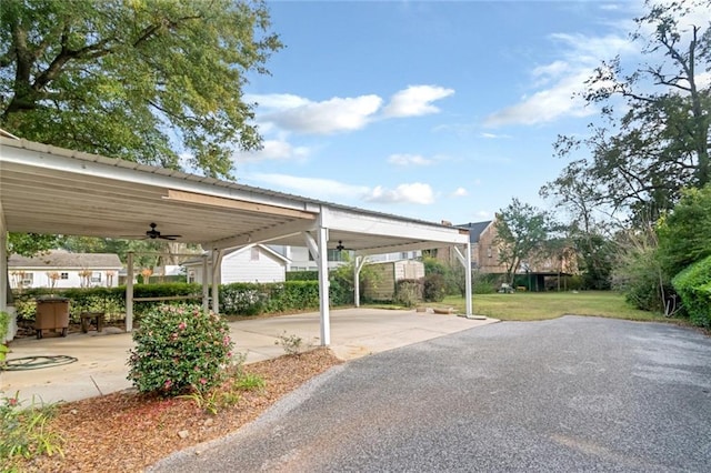 view of parking featuring a lawn and ceiling fan