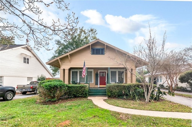 bungalow-style house with covered porch and a front yard