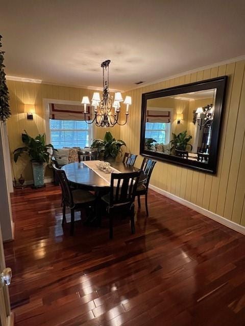 dining room with crown molding, a chandelier, plenty of natural light, and hardwood / wood-style floors