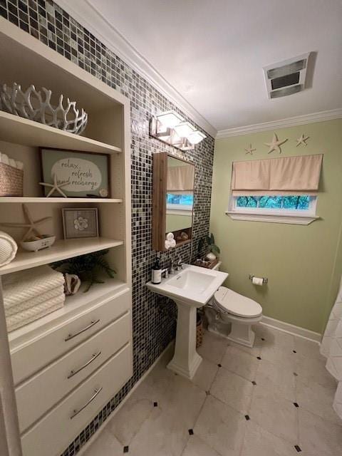 bathroom featuring visible vents, ornamental molding, and toilet