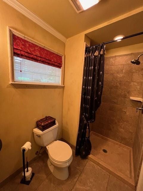 full bathroom featuring crown molding, toilet, tile patterned floors, and tiled shower