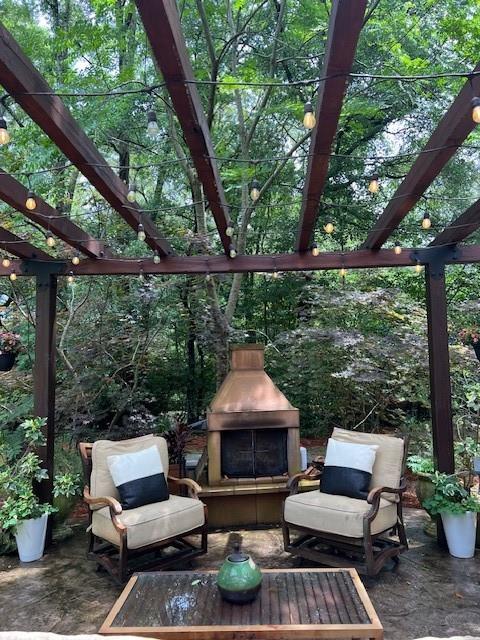 view of patio with a pergola and a fireplace
