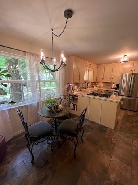 dining room with stone finish flooring and a notable chandelier