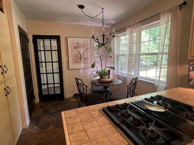 dining space featuring baseboards and a chandelier