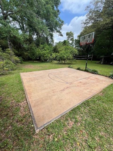 view of sport court featuring a yard and basketball court