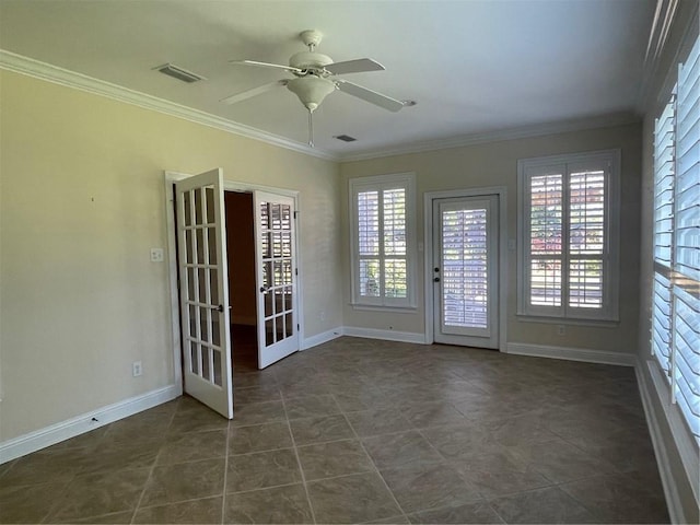 unfurnished room with dark tile patterned floors, ornamental molding, ceiling fan, and french doors