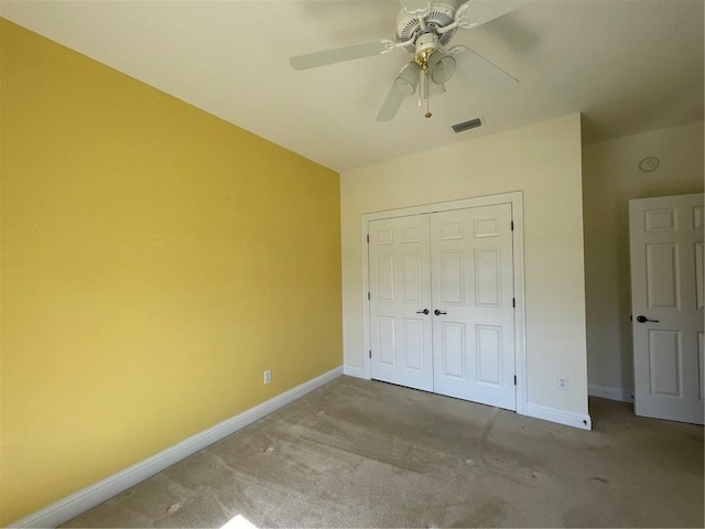 unfurnished bedroom with light colored carpet, a closet, and ceiling fan