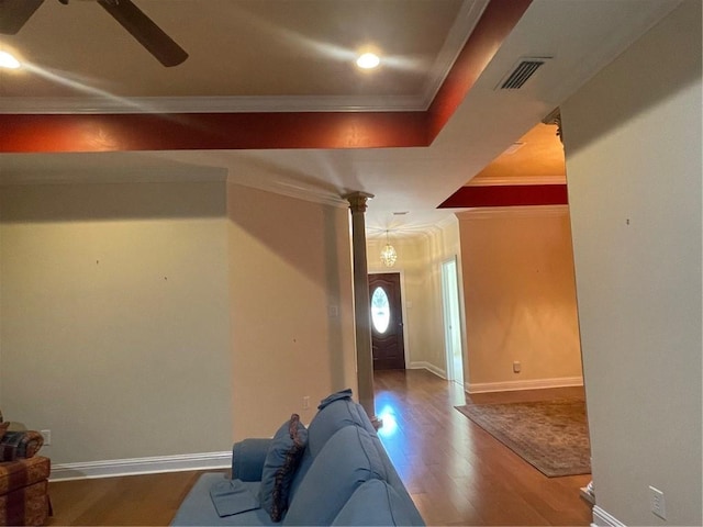 living room featuring hardwood / wood-style flooring, crown molding, and ceiling fan